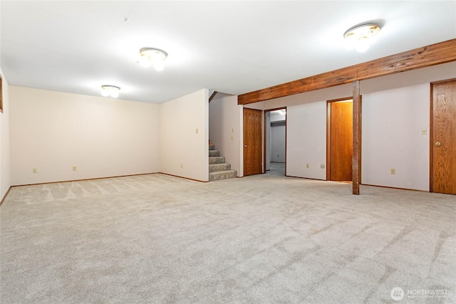 basement featuring light carpet