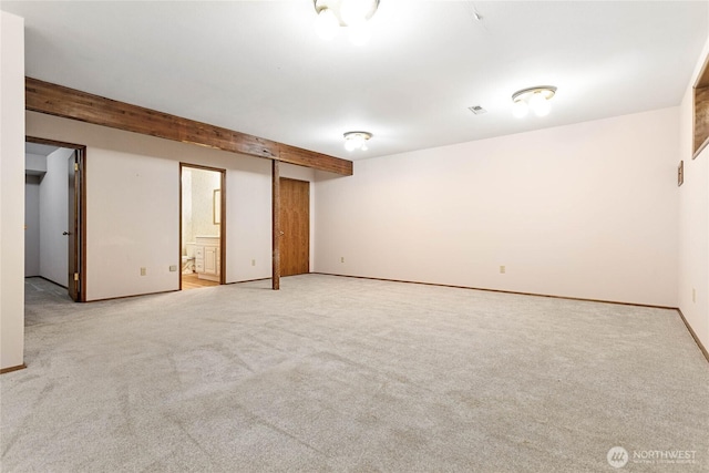 interior space featuring beamed ceiling and light carpet