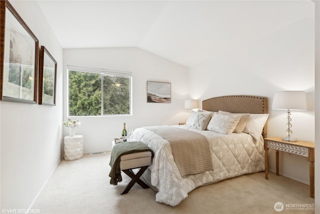 carpeted bedroom featuring lofted ceiling