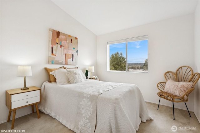 carpeted bedroom with lofted ceiling