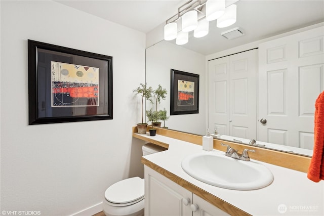 bathroom featuring toilet and vanity