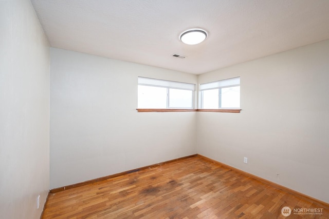 unfurnished room featuring hardwood / wood-style flooring