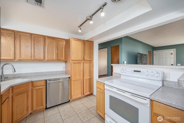 kitchen with sink, stainless steel dishwasher, white electric range, and light tile patterned floors