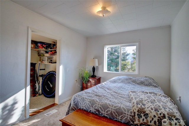 bedroom with carpet, visible vents, and a closet