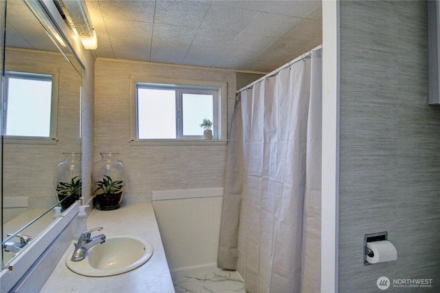 full bath featuring marble finish floor and vanity