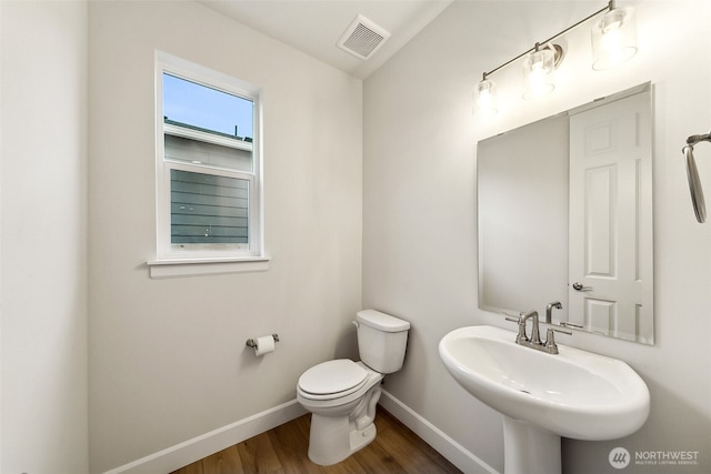 bathroom featuring sink, hardwood / wood-style flooring, and toilet