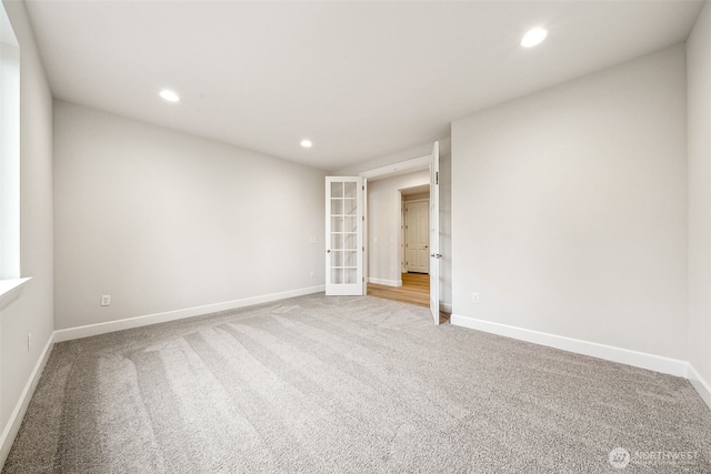 carpeted empty room featuring french doors