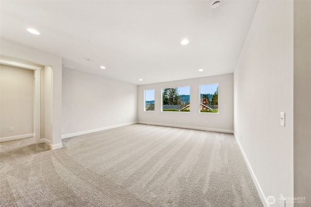 unfurnished room with light colored carpet