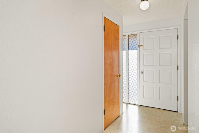 hall with a textured ceiling