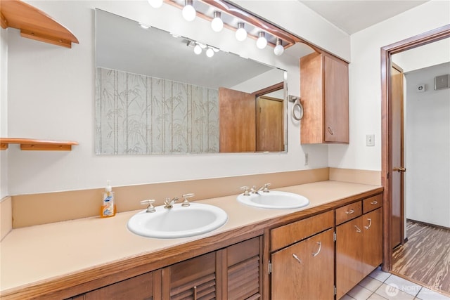 bathroom with double vanity, tile patterned flooring, and a sink