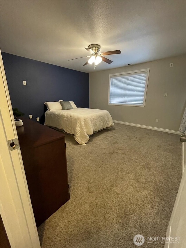 carpeted bedroom with a textured ceiling and ceiling fan