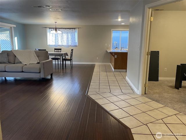 living room with light hardwood / wood-style floors and a chandelier