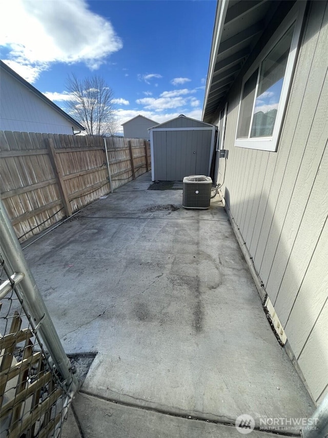 view of patio with a storage shed and central air condition unit