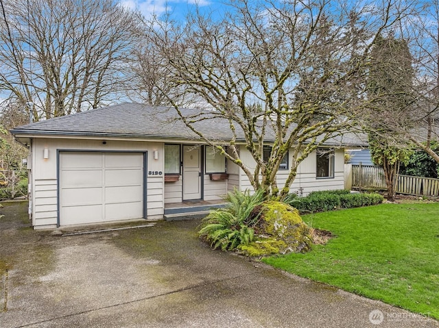 ranch-style home with a shingled roof, a front lawn, fence, a garage, and driveway