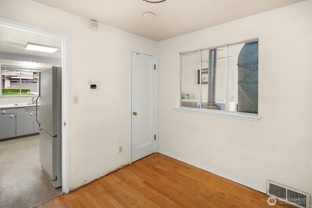 interior space with a sink, visible vents, and light wood-type flooring