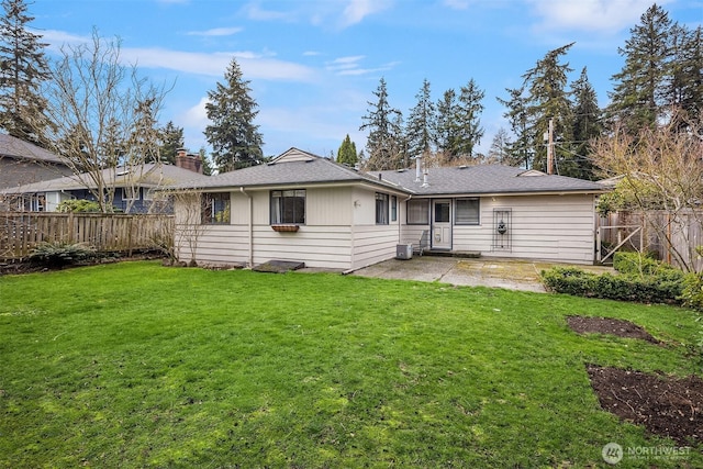 rear view of house with a patio, a lawn, a fenced backyard, and a chimney