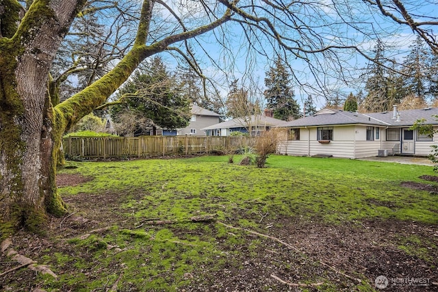 view of yard featuring a patio, central AC, and fence