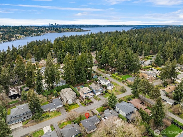 bird's eye view with a residential view, a view of trees, and a water view