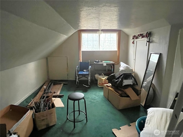 additional living space with vaulted ceiling and dark colored carpet