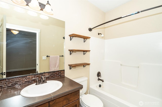 full bathroom with tasteful backsplash, vanity, toilet, and bathing tub / shower combination