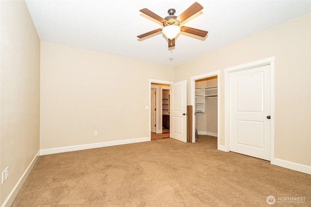 unfurnished bedroom with ceiling fan, a closet, and light carpet