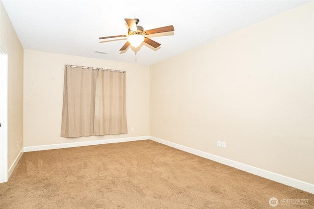 carpeted empty room featuring ceiling fan