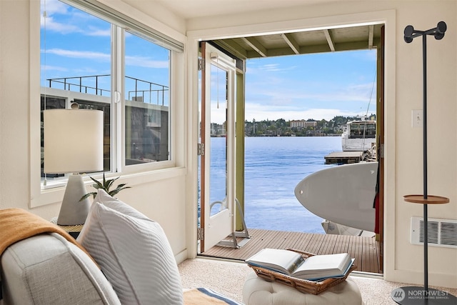 sunroom / solarium with a water view