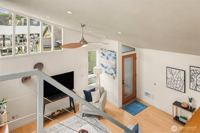 living area with recessed lighting, visible vents, a ceiling fan, vaulted ceiling, and wood finished floors