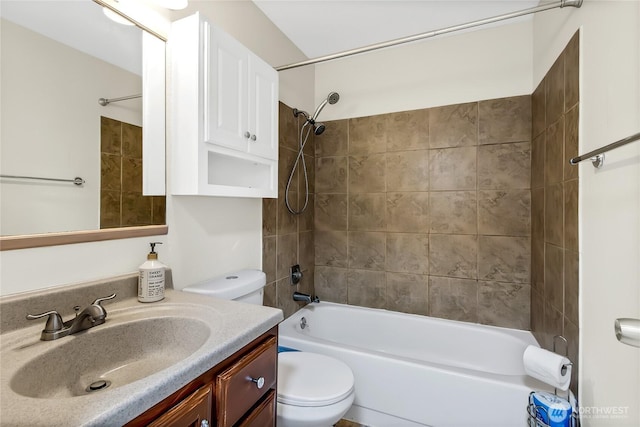 bathroom with tub / shower combination, toilet, and vanity