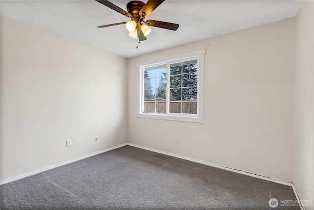 empty room featuring visible vents, baseboards, carpet floors, a textured ceiling, and a ceiling fan