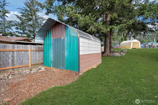 view of shed featuring fence