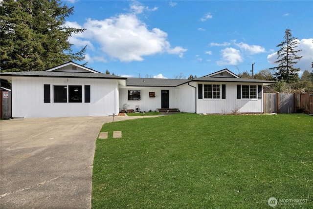 single story home with a front yard and fence