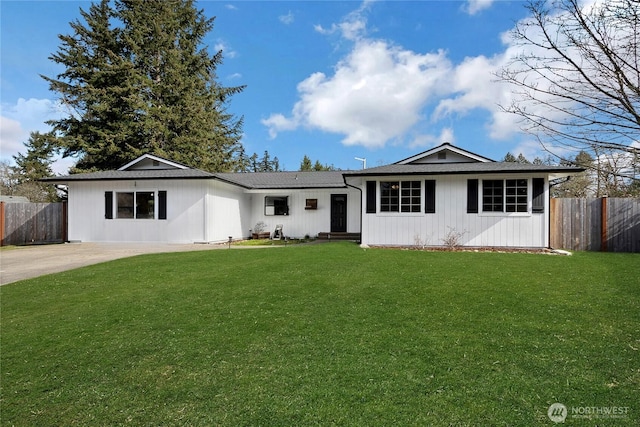 single story home featuring a front lawn, fence, and driveway