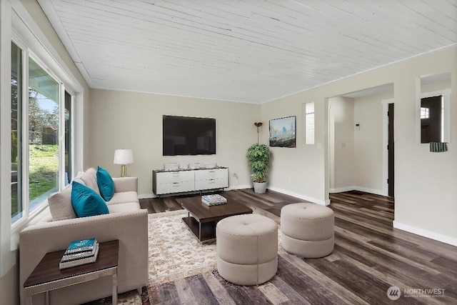 living area with wooden ceiling, wood finished floors, and baseboards