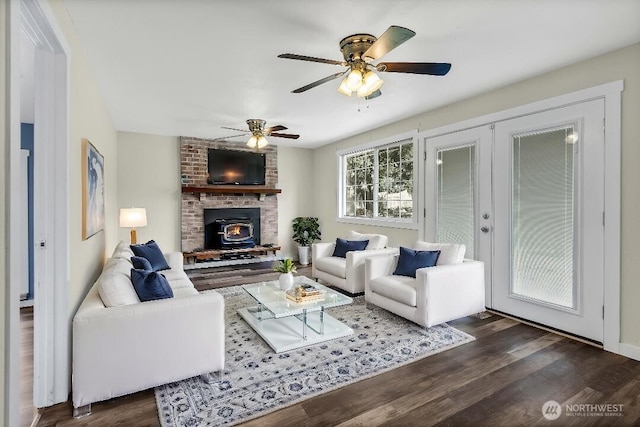 living area featuring ceiling fan and dark wood finished floors