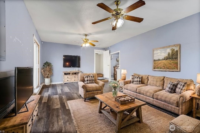 living area featuring dark wood finished floors and ceiling fan