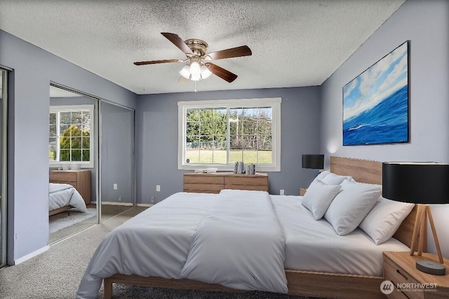 bedroom with a ceiling fan, baseboards, a closet, and a textured ceiling