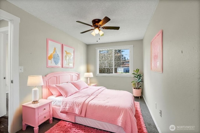 bedroom featuring a textured ceiling, a ceiling fan, baseboards, and dark colored carpet