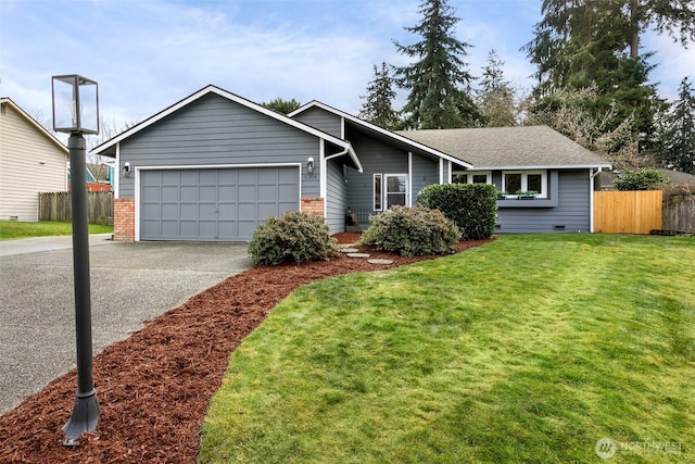 ranch-style house featuring a garage and a front lawn