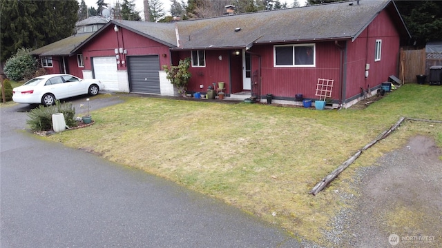 single story home with driveway, a garage, roof with shingles, a front lawn, and cooling unit