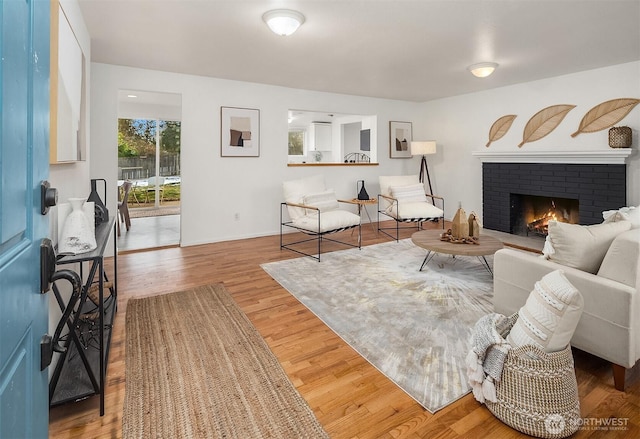 sitting room with hardwood / wood-style floors and a fireplace