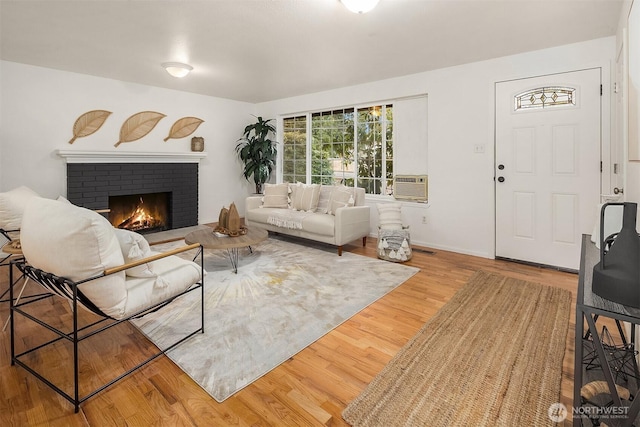 living room with hardwood / wood-style flooring and a fireplace