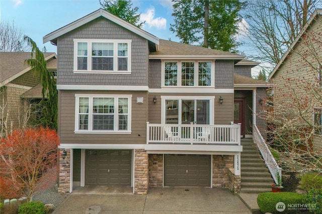 view of front of property with roof with shingles, stairs, concrete driveway, a garage, and stone siding