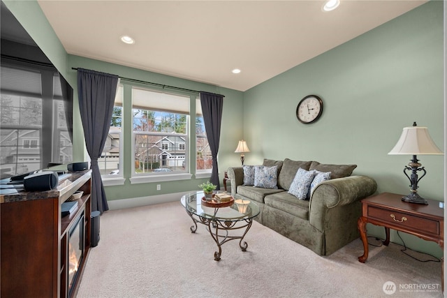 carpeted living area with recessed lighting and baseboards