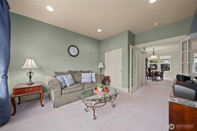 carpeted living area with recessed lighting and baseboards