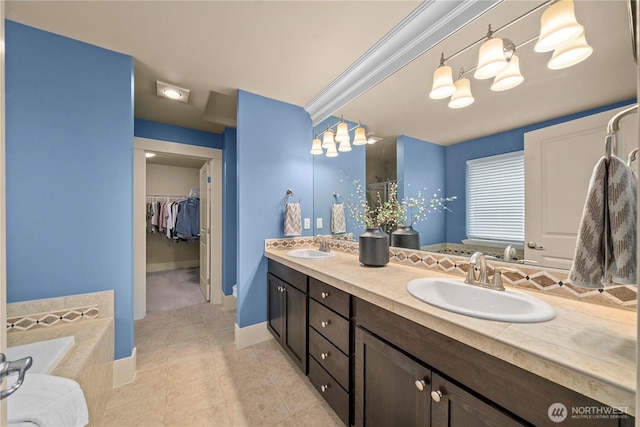 full bathroom with a sink, a walk in closet, a relaxing tiled tub, and double vanity