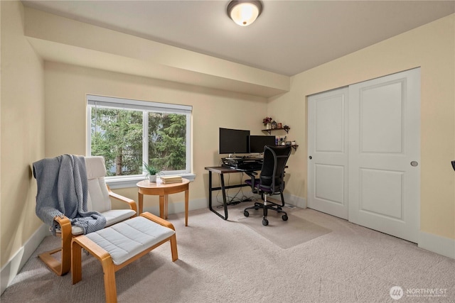 carpeted office featuring baseboards