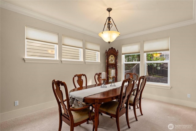 dining area with light colored carpet, baseboards, and ornamental molding