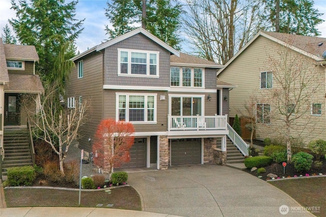 view of front of home featuring stone siding, a garage, driveway, and stairs