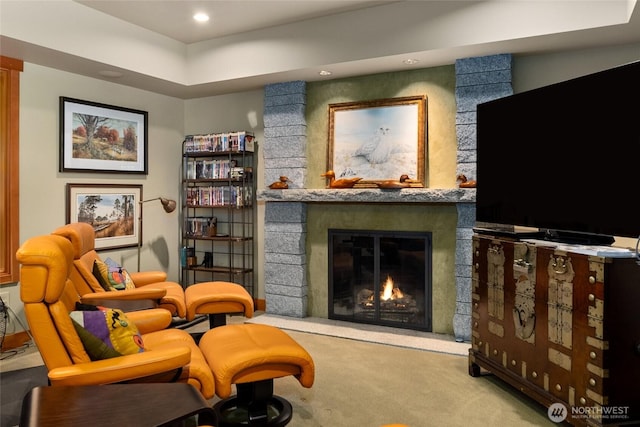 living area featuring a fireplace and light colored carpet